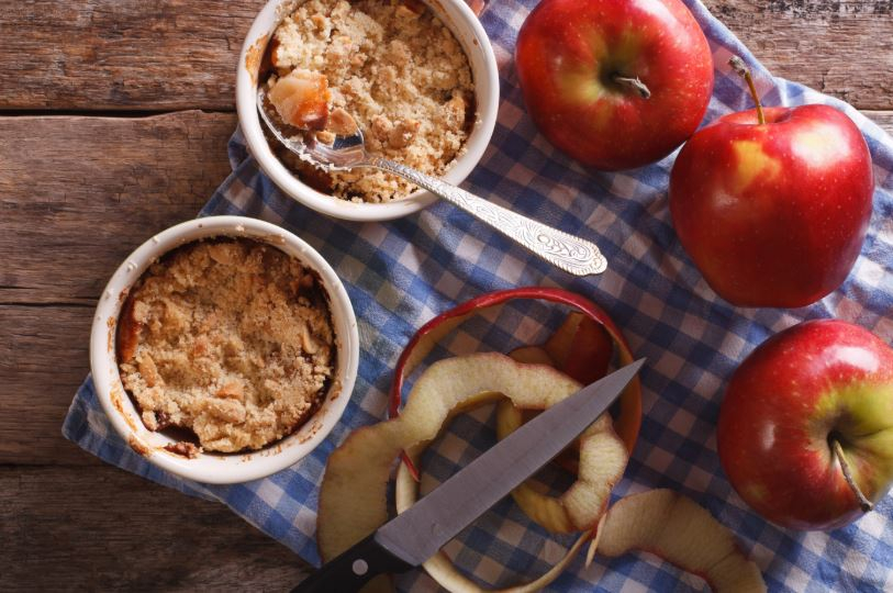 Ontario apples next to apple crumble dessert ramekins